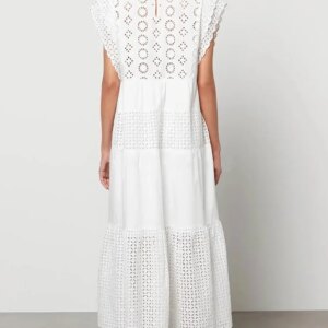 Back view of a white cotton maxi dress worn outdoors in natural light