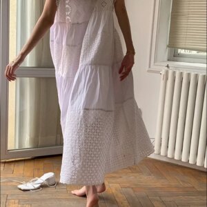 Side view of a breathable white cotton maxi dress flowing in motion
