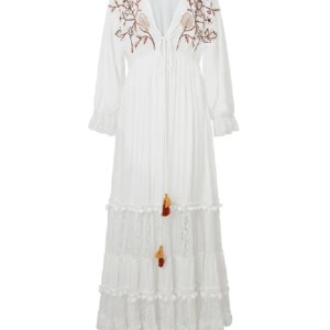 Simple Model wearing a white embroidered black and white maxi dress, standing gracefully outdoors
