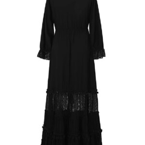 Close-up of an embroidered black and white maxi dress, showing detailed stitching on the fabric.